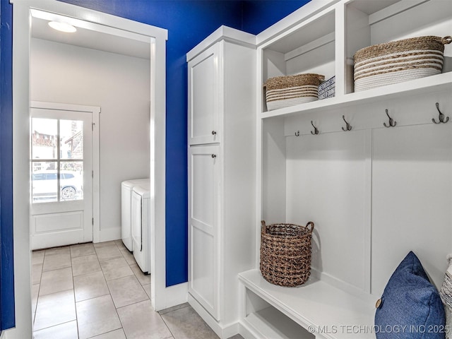 mudroom featuring light tile patterned flooring and washer and clothes dryer