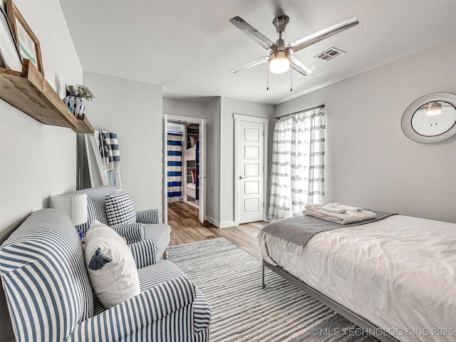 bedroom with visible vents, a closet, a ceiling fan, and light wood finished floors