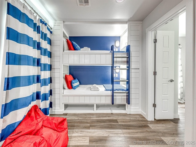 bathroom featuring wood finished floors and visible vents