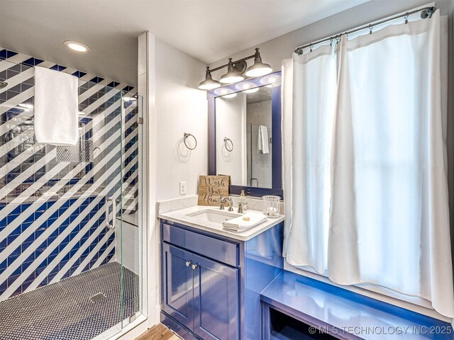 bathroom featuring recessed lighting, a stall shower, and vanity