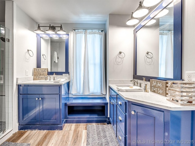 bathroom featuring vanity, a shower with shower curtain, and wood finished floors