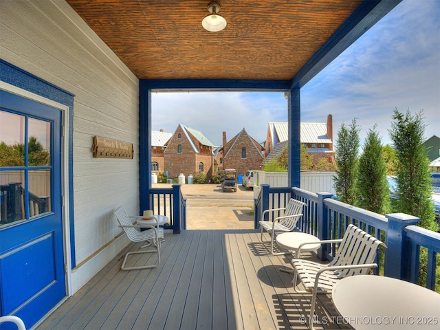 wooden terrace with a residential view