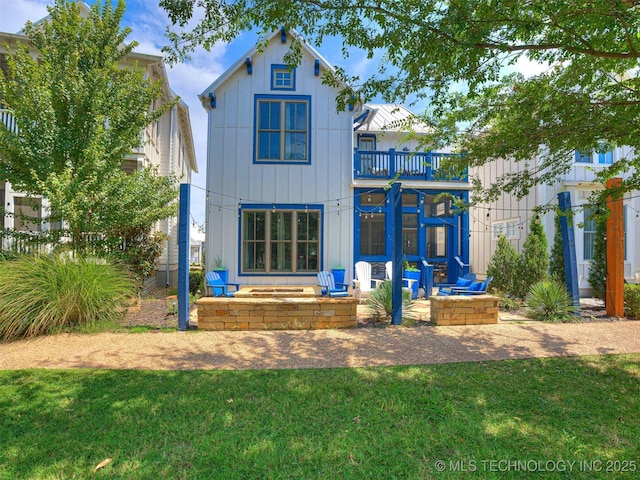 back of property featuring a patio area, a lawn, and a balcony