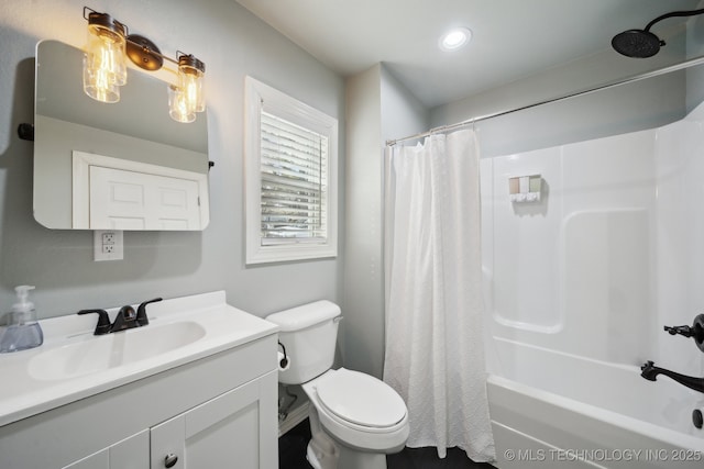 bathroom with vanity, shower / tub combo, and toilet