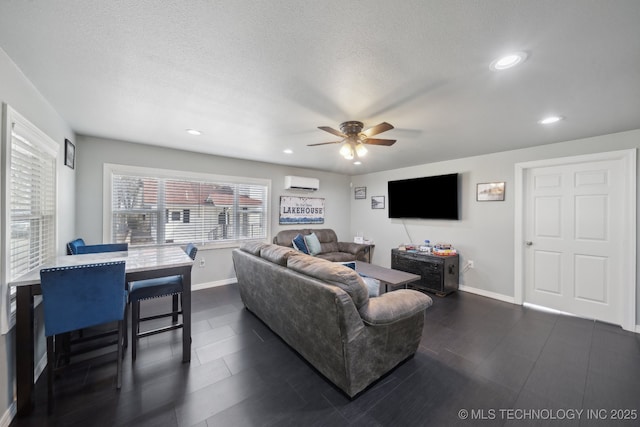 living area with a wall mounted air conditioner, baseboards, and recessed lighting