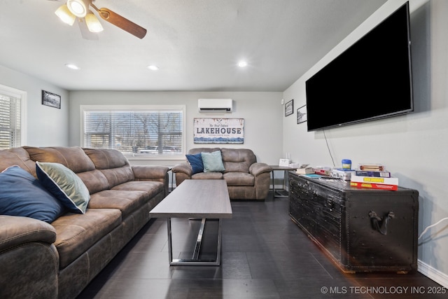 living room with recessed lighting, a ceiling fan, and a wall unit AC