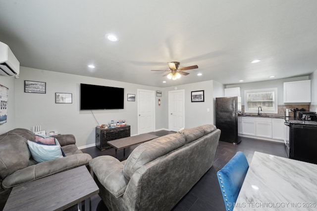 living room featuring recessed lighting, baseboards, a ceiling fan, and a wall mounted AC