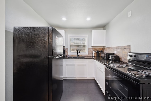 kitchen featuring black appliances, a sink, dark countertops, white cabinetry, and decorative backsplash