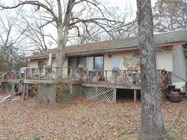 rear view of house with a wooden deck