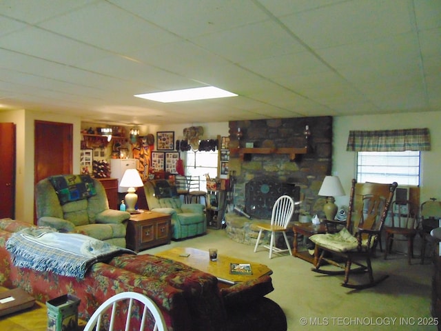 carpeted living room featuring a fireplace and a healthy amount of sunlight