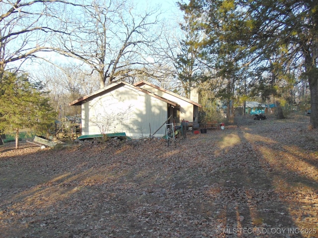 view of property exterior featuring a chimney