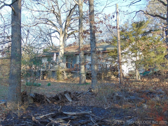 rear view of property featuring a wooden deck