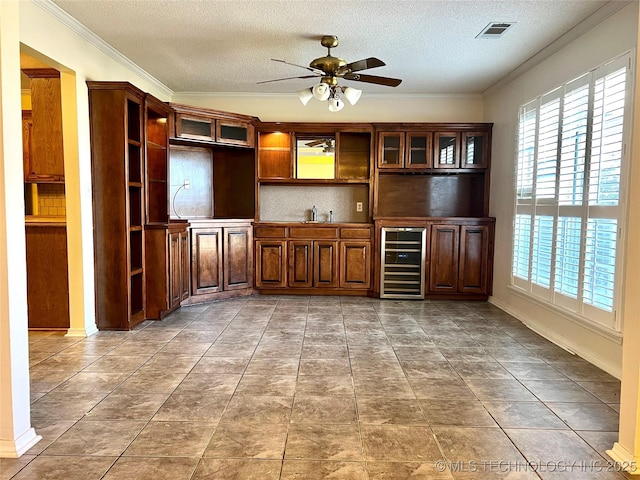 bar with visible vents, beverage cooler, decorative backsplash, and ornamental molding