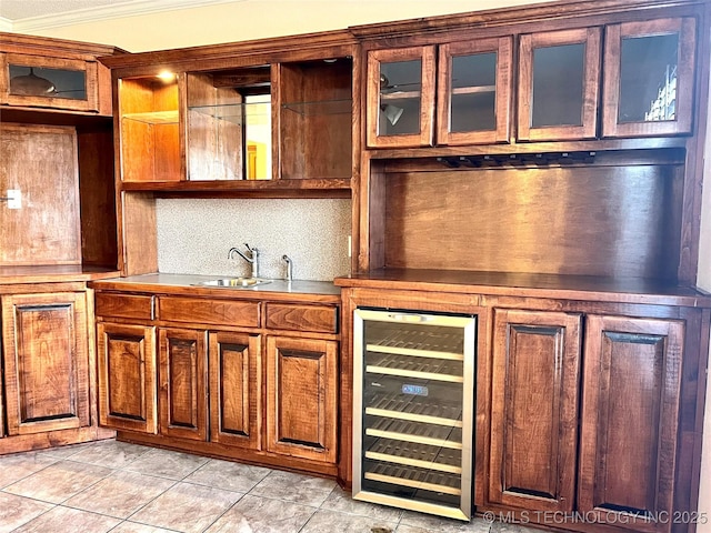 kitchen with backsplash, glass insert cabinets, crown molding, wine cooler, and a sink