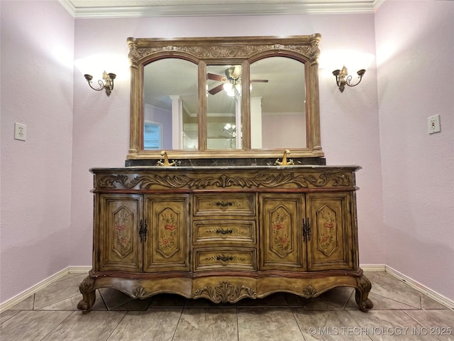 bathroom featuring a sink, baseboards, ornamental molding, and double vanity