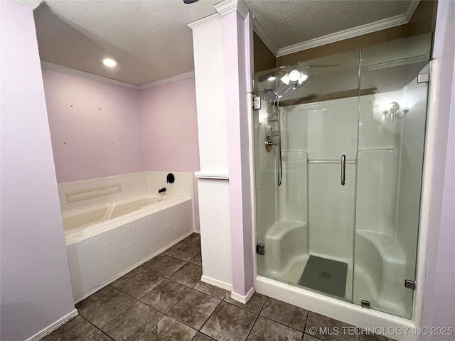 full bath featuring tile patterned floors, a garden tub, ornamental molding, a textured ceiling, and a shower stall