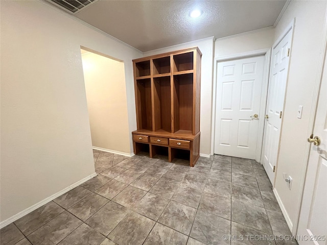 mudroom with visible vents, baseboards, and ornamental molding