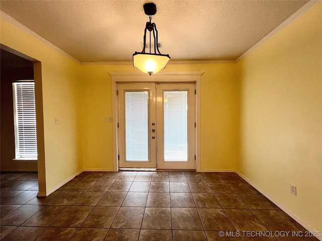 interior space featuring crown molding, dark tile patterned floors, french doors, and a textured ceiling