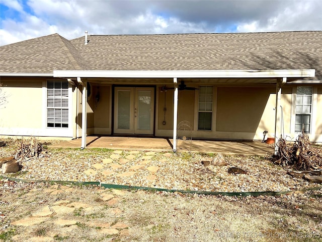 back of property featuring a patio area, french doors, and roof with shingles