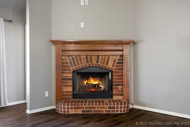 interior details featuring baseboards, wood finished floors, and a fireplace