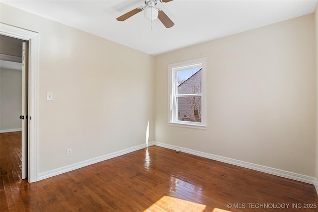 unfurnished room featuring hardwood / wood-style floors, a ceiling fan, and baseboards