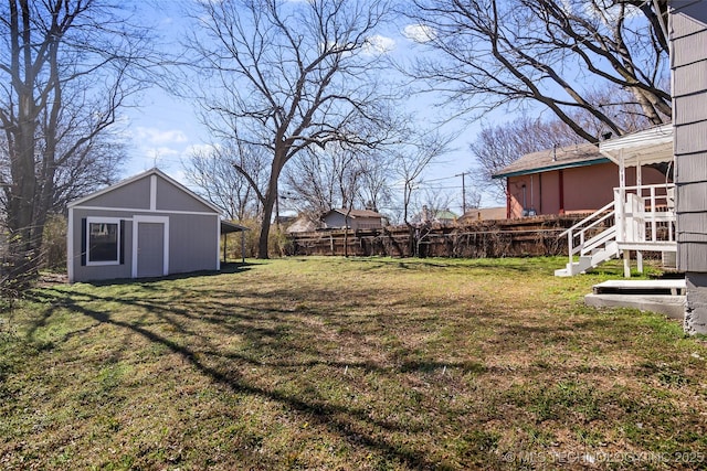 view of yard featuring an outbuilding and fence