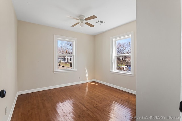 empty room featuring hardwood / wood-style flooring, baseboards, a wealth of natural light, and ceiling fan