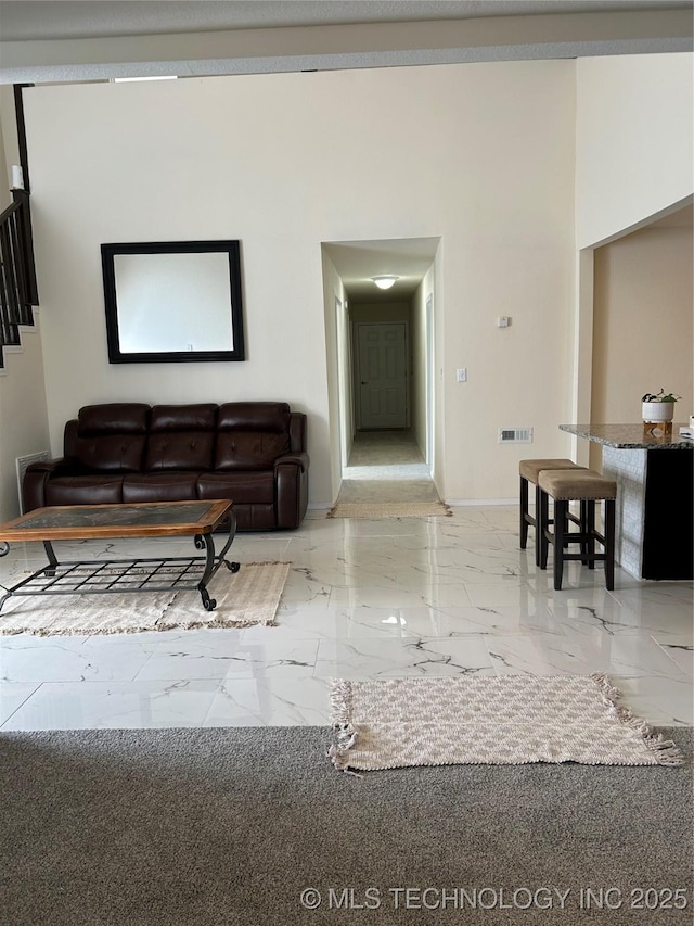 living room with visible vents, marble finish floor, and baseboards