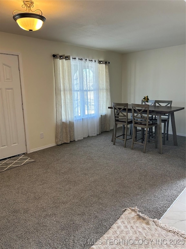 carpeted dining space with baseboards