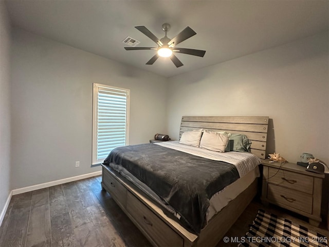 bedroom with ceiling fan, visible vents, baseboards, and dark wood finished floors