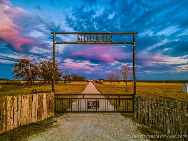 exterior space with a rural view and a gate