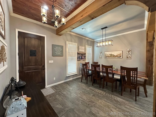 dining area featuring visible vents, dark wood-type flooring, a notable chandelier, crown molding, and baseboards