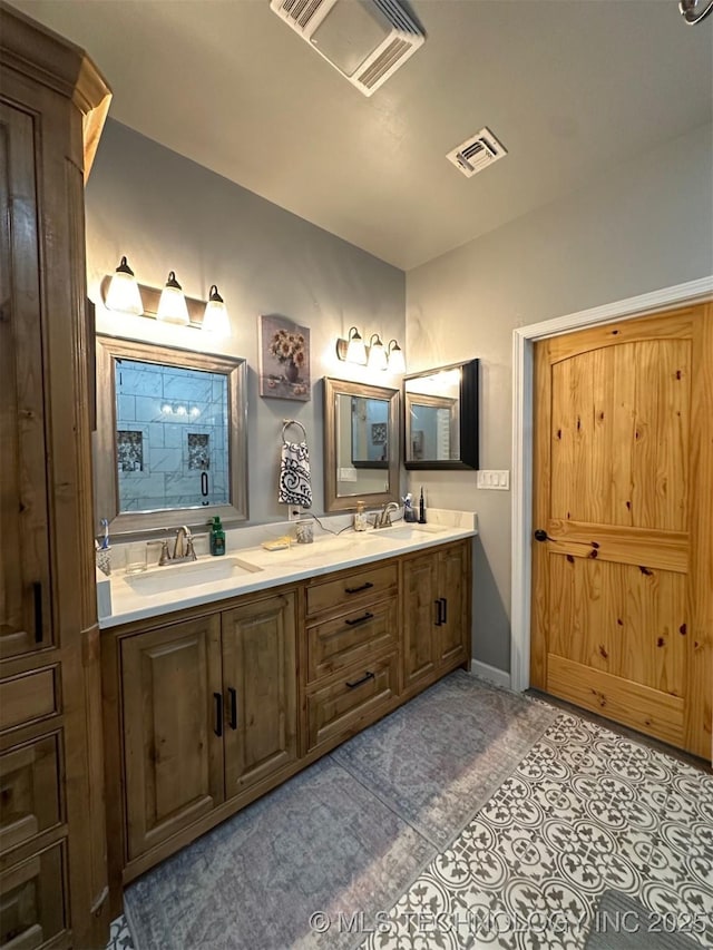 bathroom featuring double vanity, visible vents, and a sink