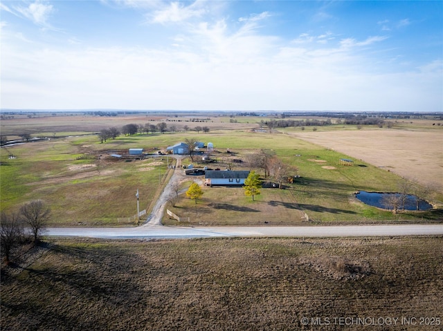 birds eye view of property with a rural view