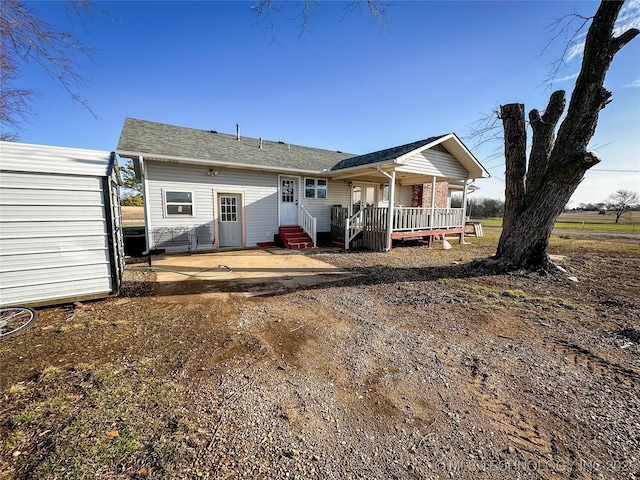 rear view of property with entry steps