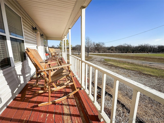 balcony featuring covered porch and a sunroom