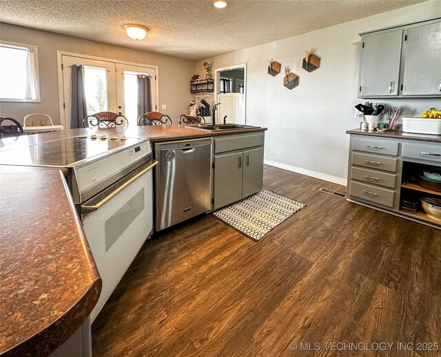 kitchen with range with electric stovetop, french doors, stainless steel dishwasher, dark wood-style floors, and a sink