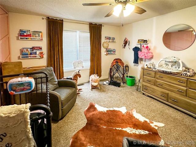 bedroom featuring baseboards, a textured ceiling, a ceiling fan, and carpet floors