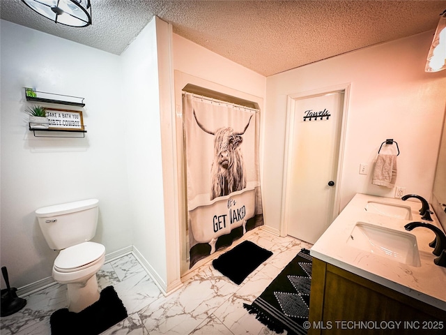 bathroom with a sink, baseboards, toilet, and marble finish floor