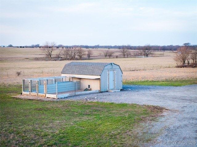 view of shed featuring a garden, a rural view, and fence