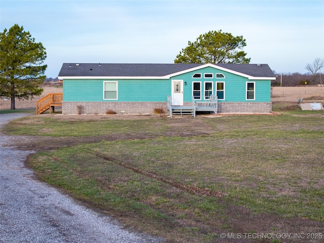 view of front of home with brick siding and a front lawn