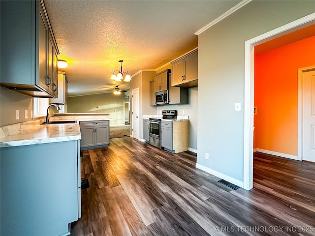 kitchen with a sink, stainless steel appliances, dark wood-type flooring, light countertops, and a textured ceiling