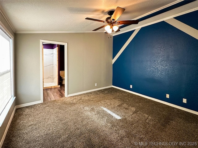 unfurnished bedroom featuring baseboards, a textured ceiling, carpet, and ornamental molding