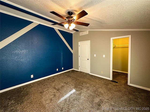 unfurnished bedroom with visible vents, carpet, lofted ceiling, and ornamental molding