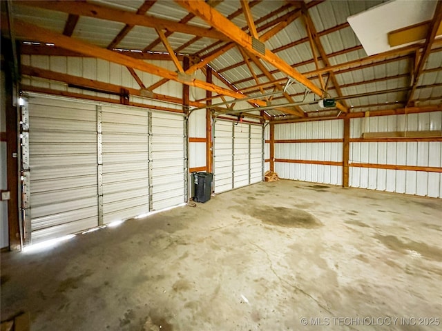 garage featuring a garage door opener and metal wall