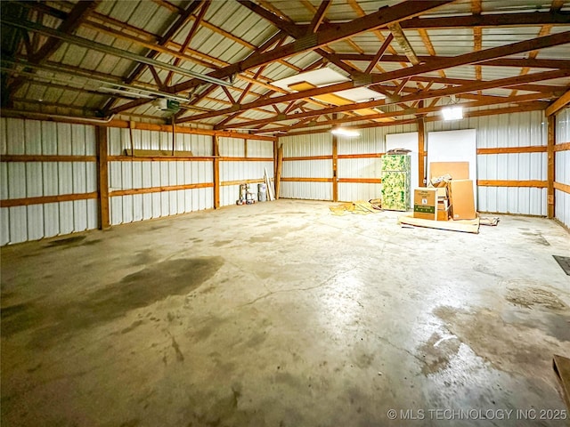 garage with a garage door opener and metal wall