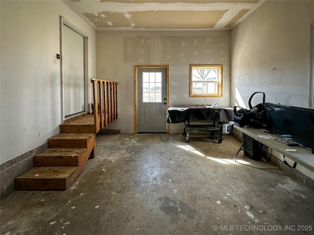 foyer with unfinished concrete flooring