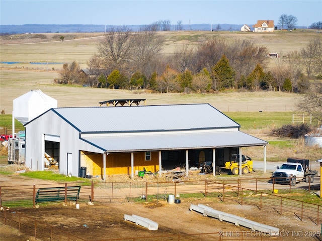 exterior space with an exterior structure, a rural view, and an outdoor structure