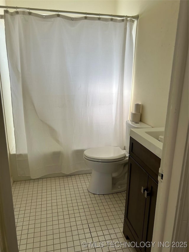 339 W 62nd St N, Tulsa, OK 74126 - bathroom with vanity, tile patterned floors, toilet, and shower / bath combo with shower curtain