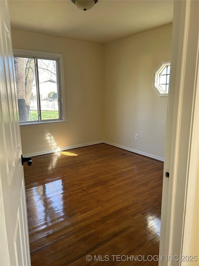 339 W 62nd St N, Tulsa, OK 74126 - empty room with baseboards and dark wood-style flooring